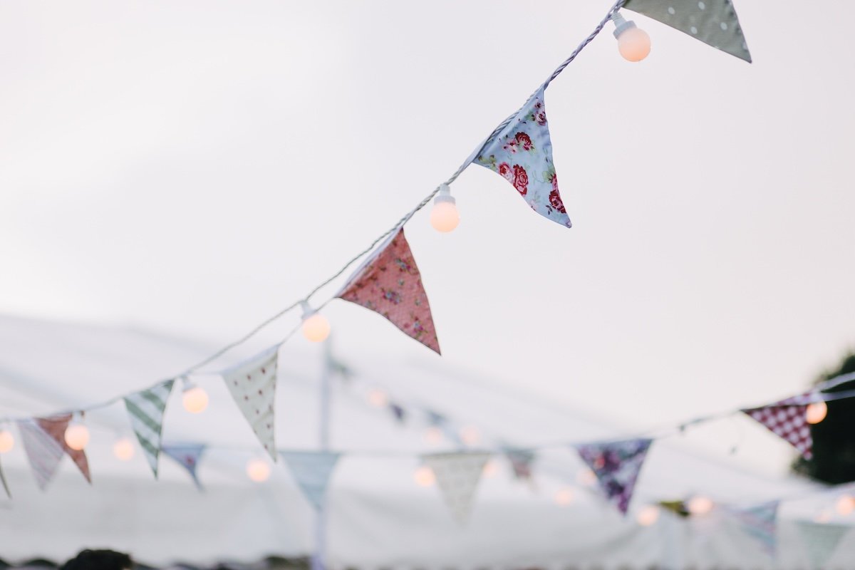 Bunting with different designs hanging with light bulbs and rope