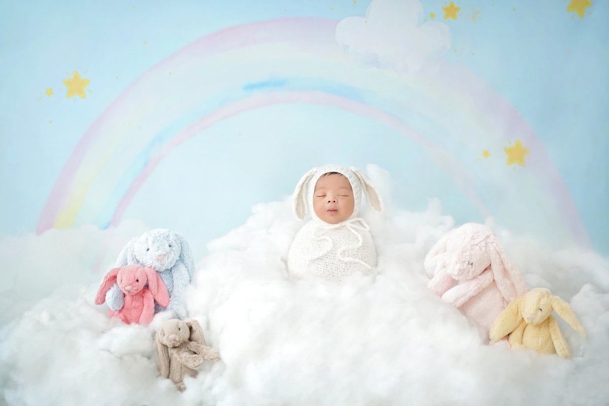 Cute picture of a baby with a rainbow background
