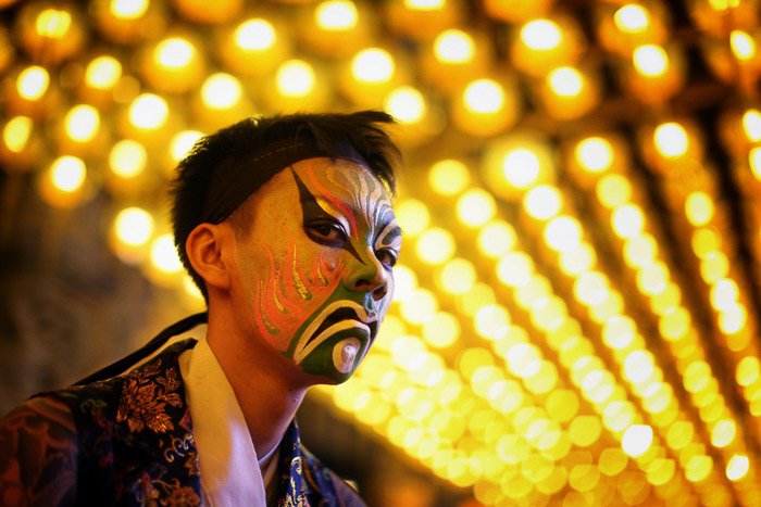 A man dressed up for carnival with distinctive bokeh background created using a wide aperture