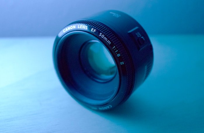 Blue-lit image of a Canon EF 50mm lens