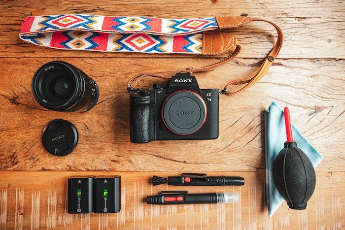 A flat lay of a Sony a7 III camera body and accessories