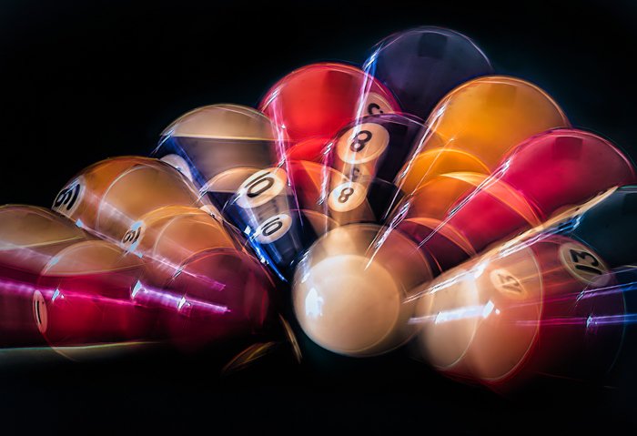 Photo of colorful pool balls with slow sync flash